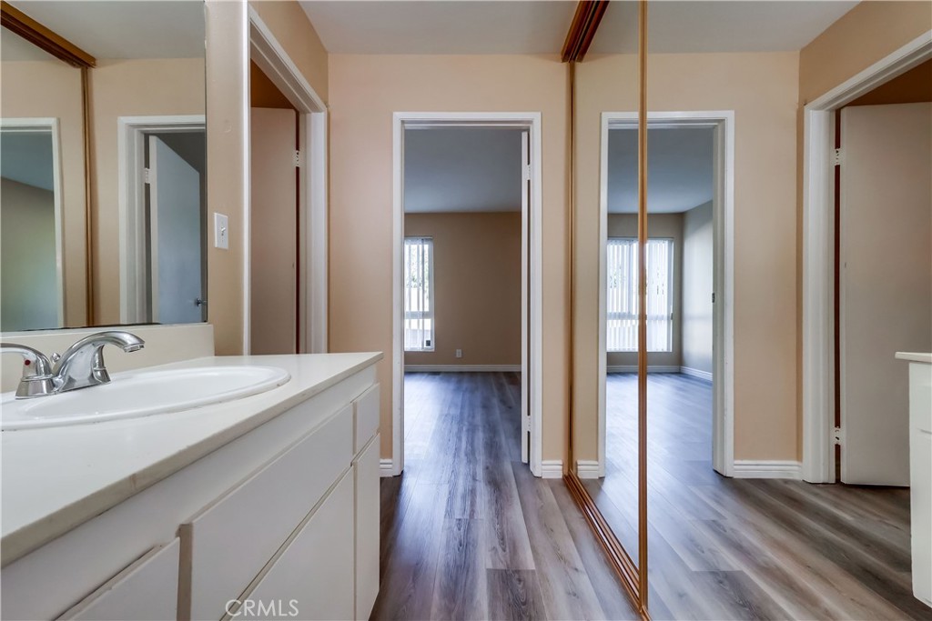 5585 Pacific Coast Highway, Unit 140 Long Beach, CA 90804 - Photo 25 of 47 a en suite bathroom with a sink and a large mirror