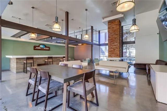 a living room with a table chairs and a wooden floor