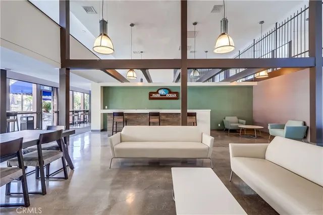 a living room with furniture a ceiling fan and a large window