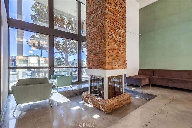 a living room with furniture and a floor to ceiling window