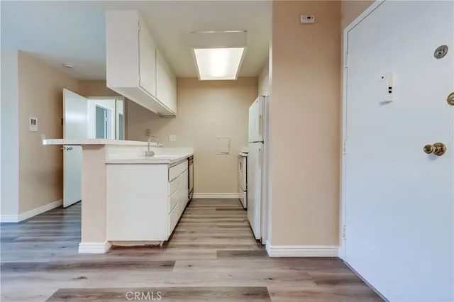a utility room with cabinets washer and dryer