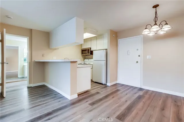 a view of a kitchen with wooden floor and a sink