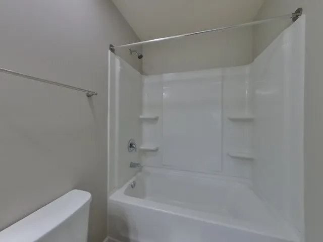 a view of room with window and wooden floor