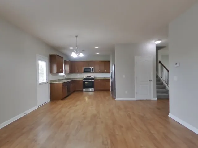 a large white kitchen with a cabinetry and kitchen island