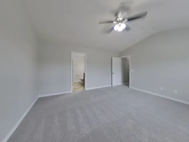 a view of an empty room with a ceiling fan
