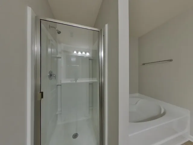 a bathroom with a glass shower door