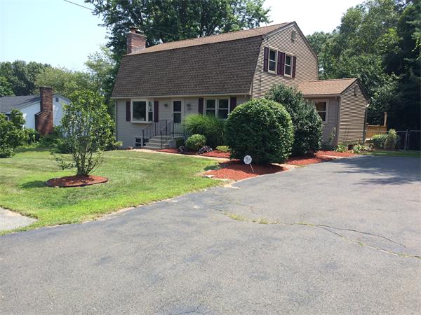 a view of a house with backyard and tree s