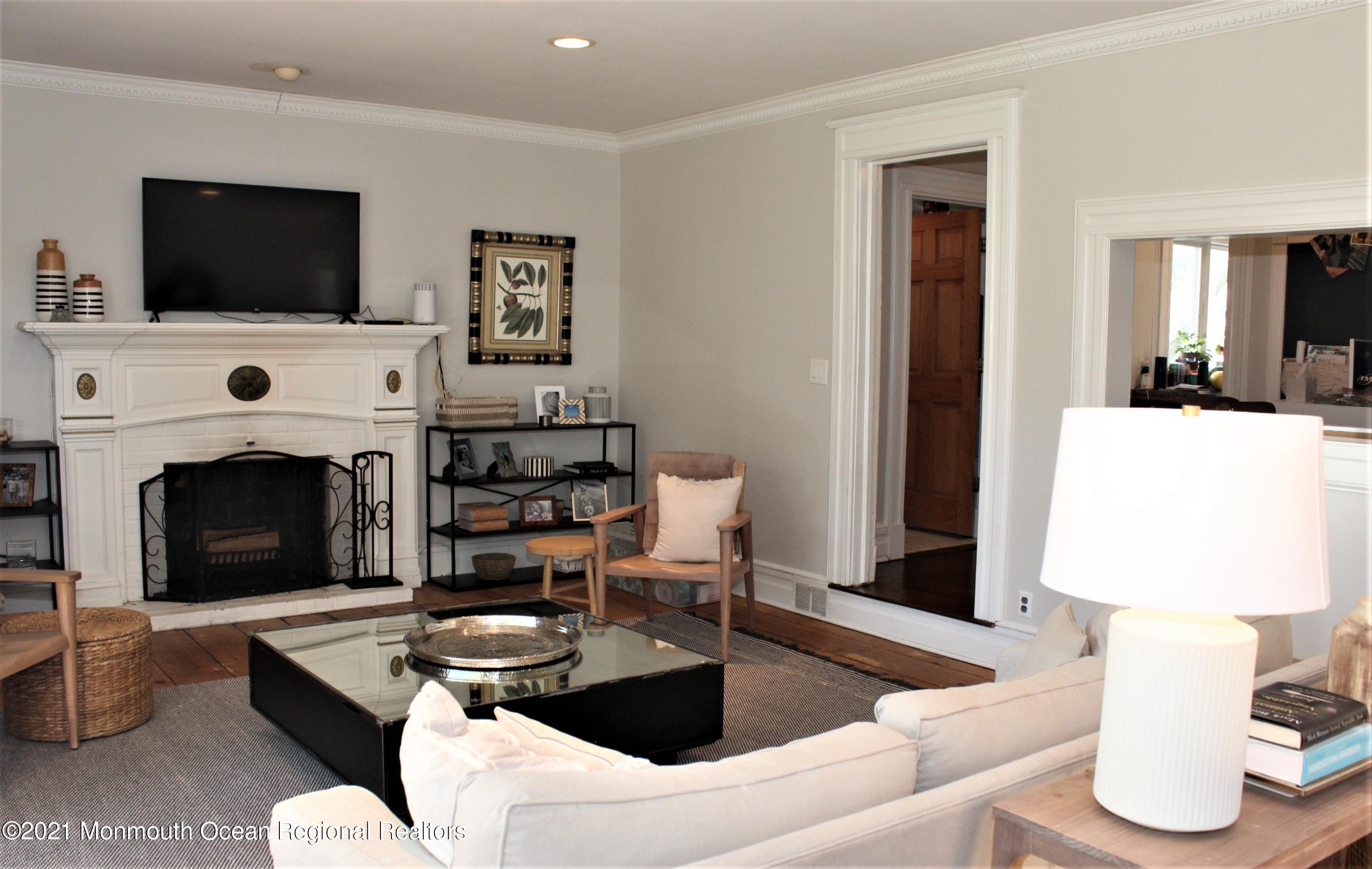 675 River Road Fair Haven, NJ 07704 - Photo 2 of 36 a living room with furniture and a fireplace