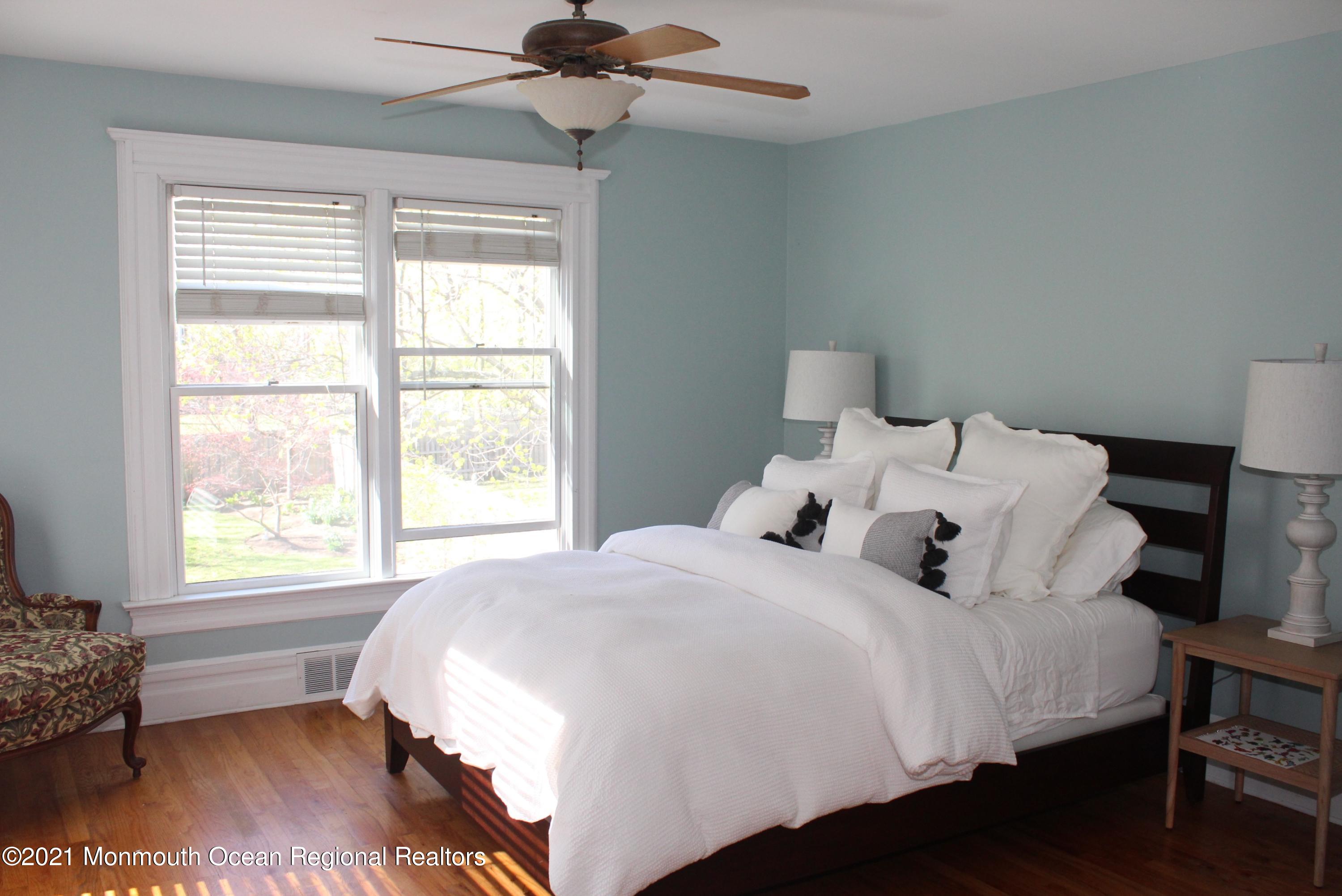 675 River Road Fair Haven, NJ 07704 - Photo 16 of 36 a bedroom with bed window and lamp