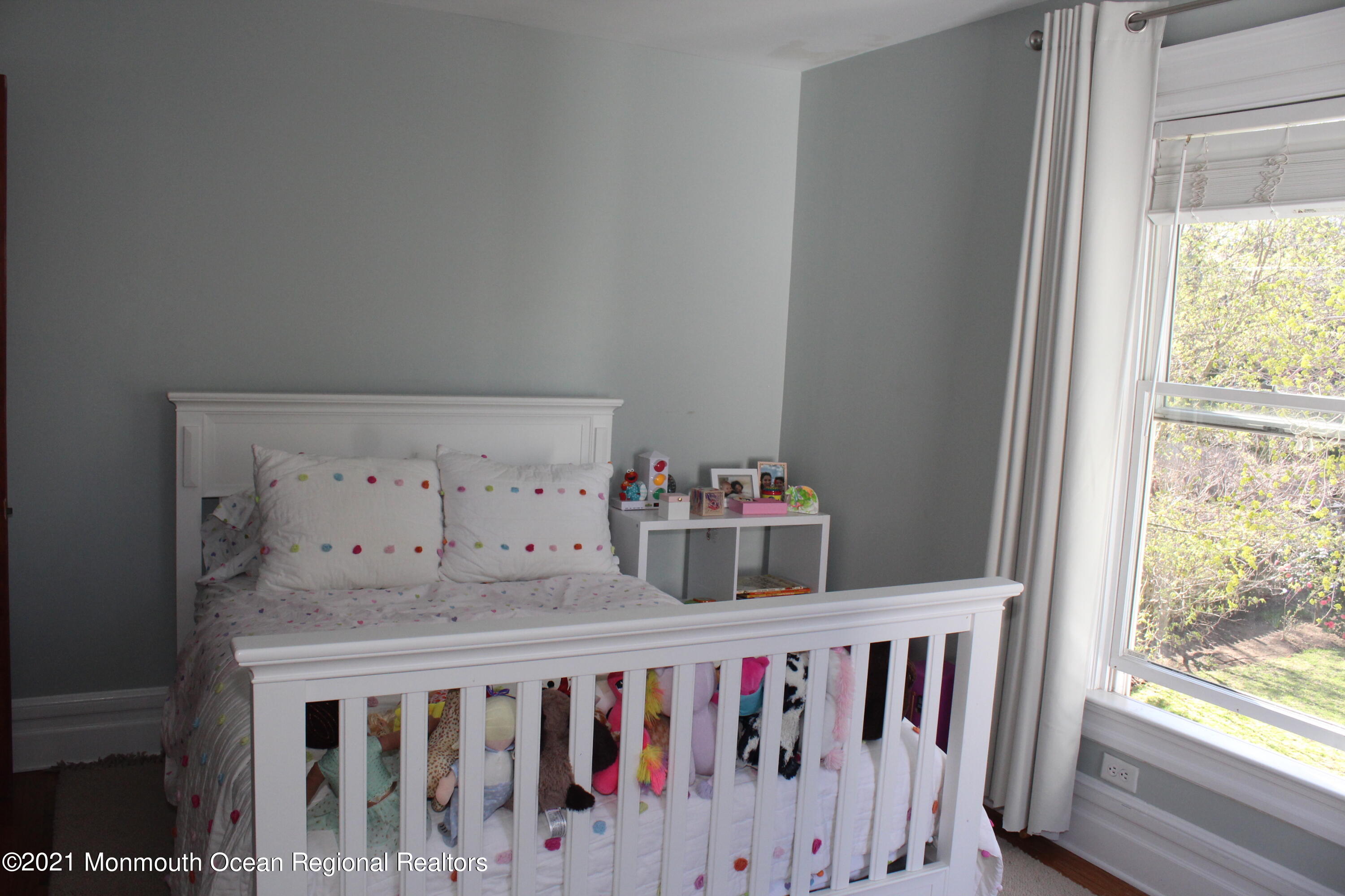 675 River Road Fair Haven, NJ 07704 - Photo 19 of 36 a bedroom with a bed and a window