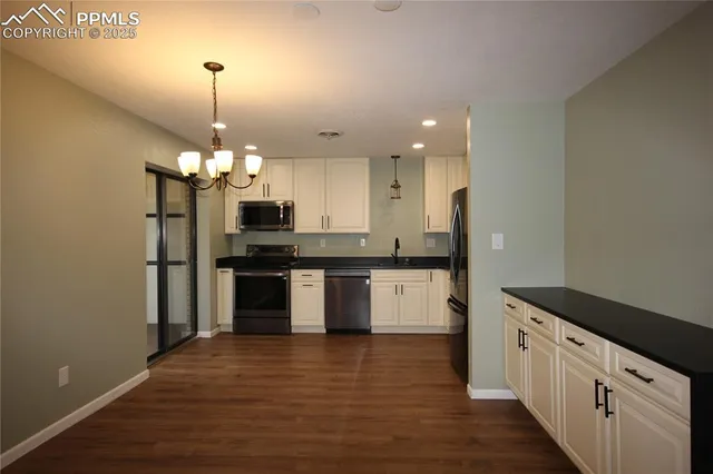 a kitchen with stainless steel appliances granite countertop a refrigerator sink and cabinets