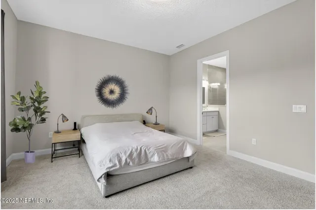 a bedroom with a bed and a potted plant
