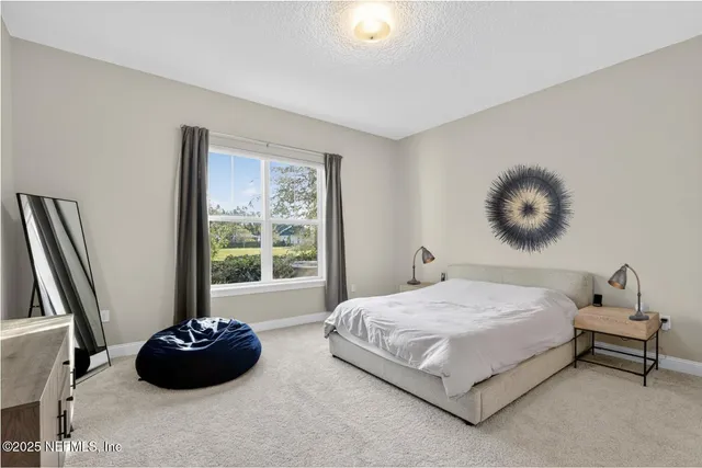 a bedroom with a bed and a large window