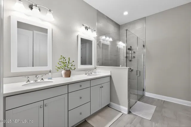 a bathroom with a double vanity sink mirror and