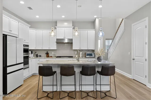 a kitchen that has a table and chairs in it