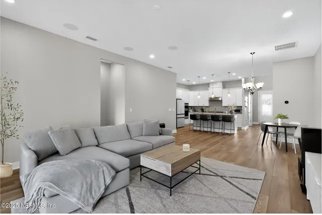 a living room with furniture and kitchen view