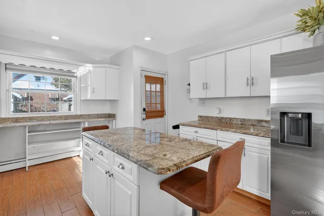 a kitchen with granite countertop a stove and a sink