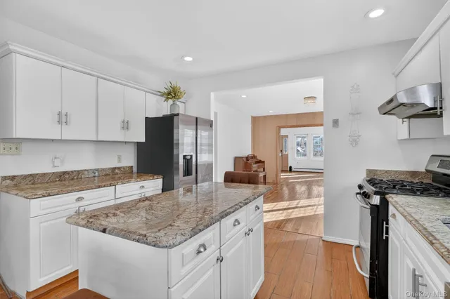 a kitchen with stainless steel appliances granite countertop a sink stove and refrigerator