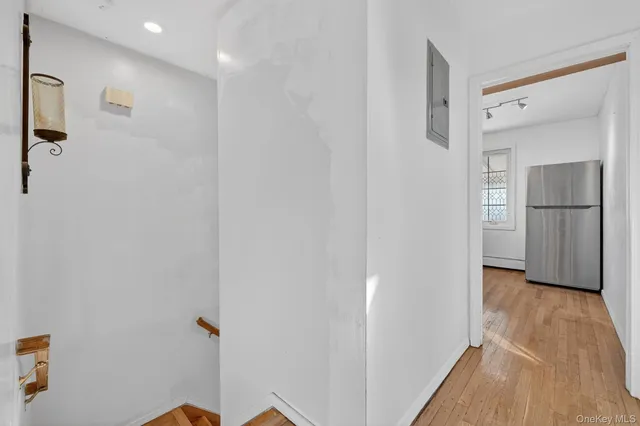 a view of a hallway with wooden floor