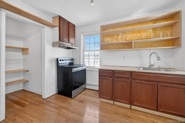 a kitchen with stainless steel appliances granite countertop a sink and cabinets