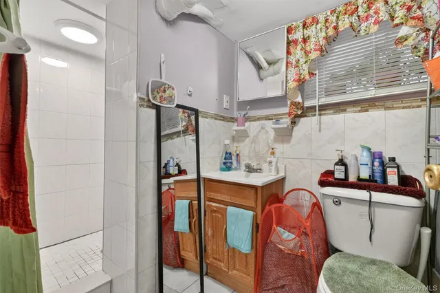 a bathroom with a sink a toilet and mirror