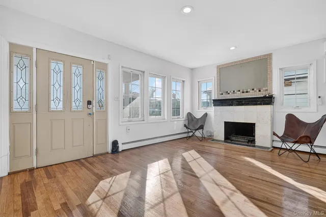 a view of a livingroom with a fireplace and window