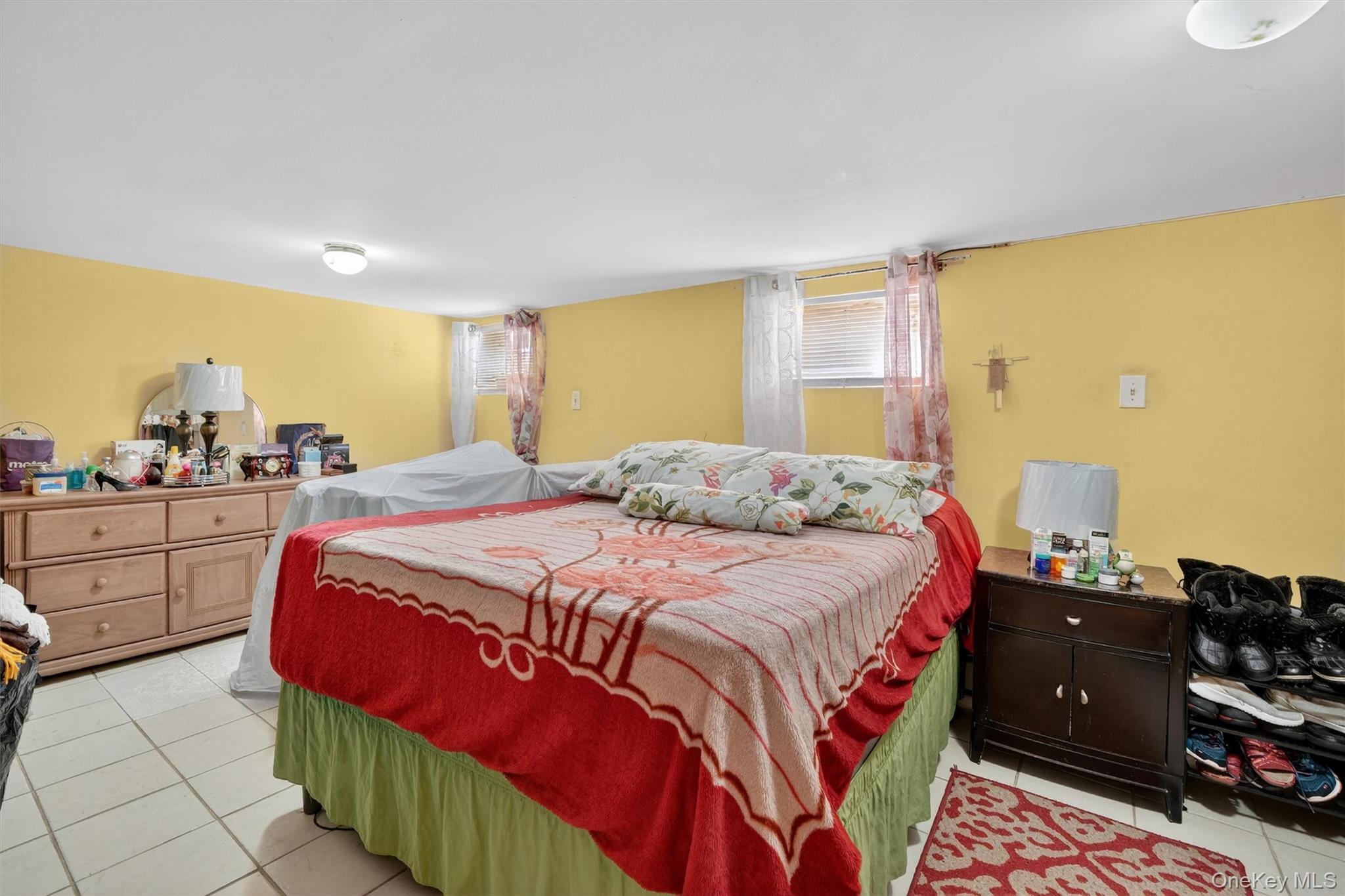 138-16 230th Street Queens, NY 11413 - Photo 41 of 49 Basement bedroom with light tile patterned flooring