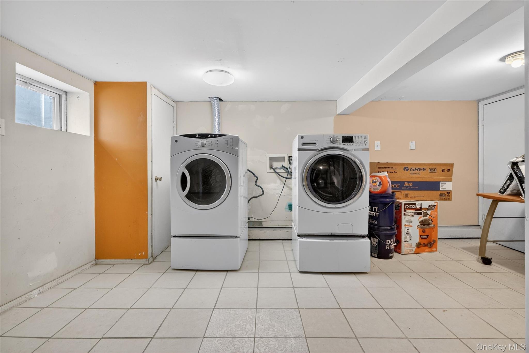 138-16 230th Street Queens, NY 11413 - Photo 43 of 49 Basement washroom featuring washer and clothes dryer, light tile patterned flooring, and a baseboard heating unit
