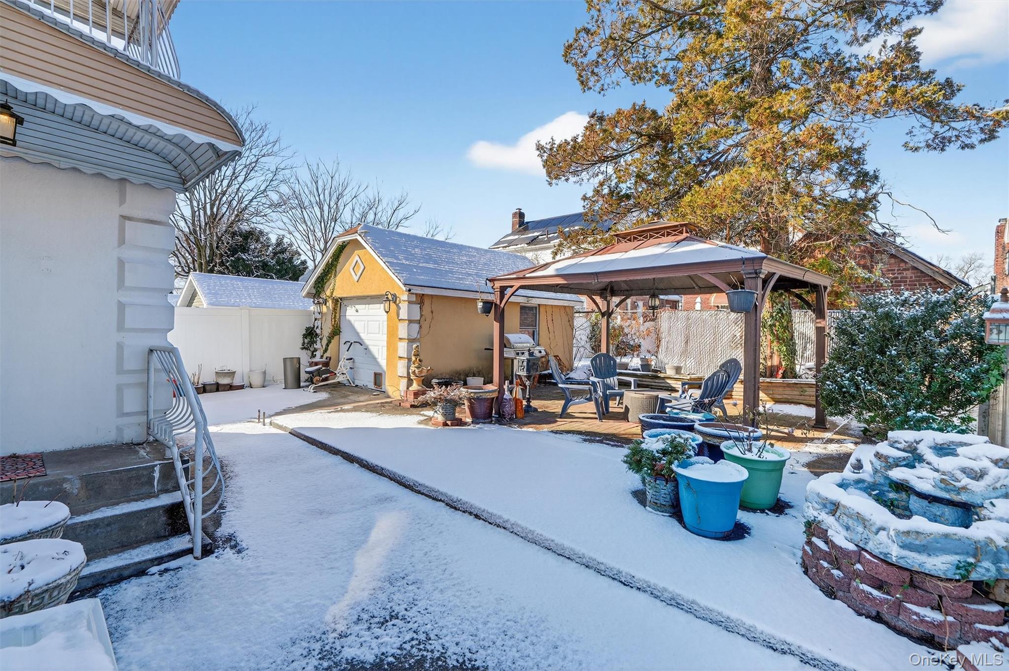 138-16 230th Street Queens, NY 11413 - Photo 44 of 49 Patio with a gazebo, an outdoor structure, a patio, a fire pit, and a garage