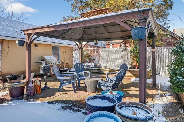 a view of a patio with table and chairs under an umbrella