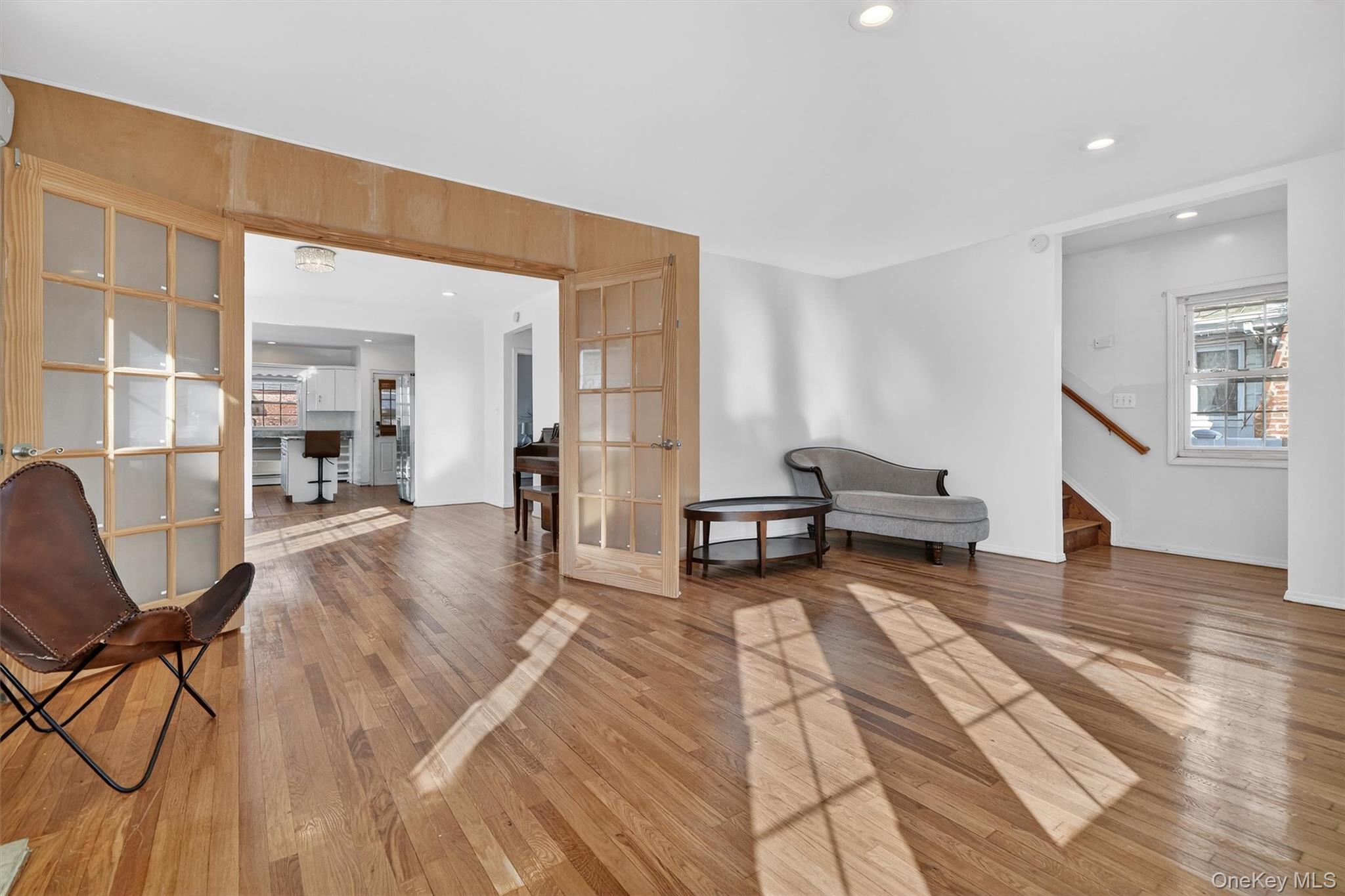 138-16 230th Street Queens, NY 11413 - Photo 5 of 49 Living area with french doors, recessed lighting, and light wood-style flooring
