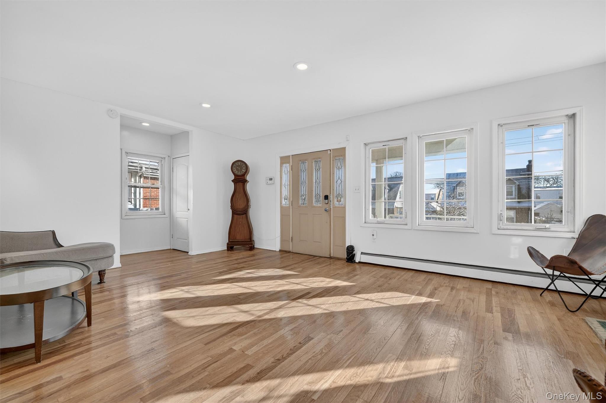 138-16 230th Street Queens, NY 11413 - Photo 6 of 49 Foyer entrance featuring a baseboard radiator, light wood-style flooring, and recessed lighting