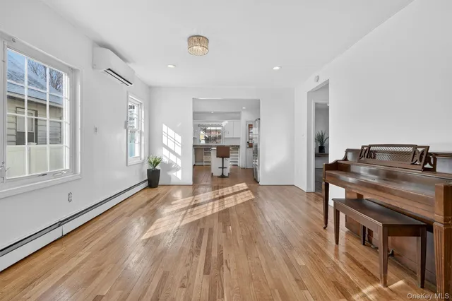 a view of a room with wooden floor and furniture