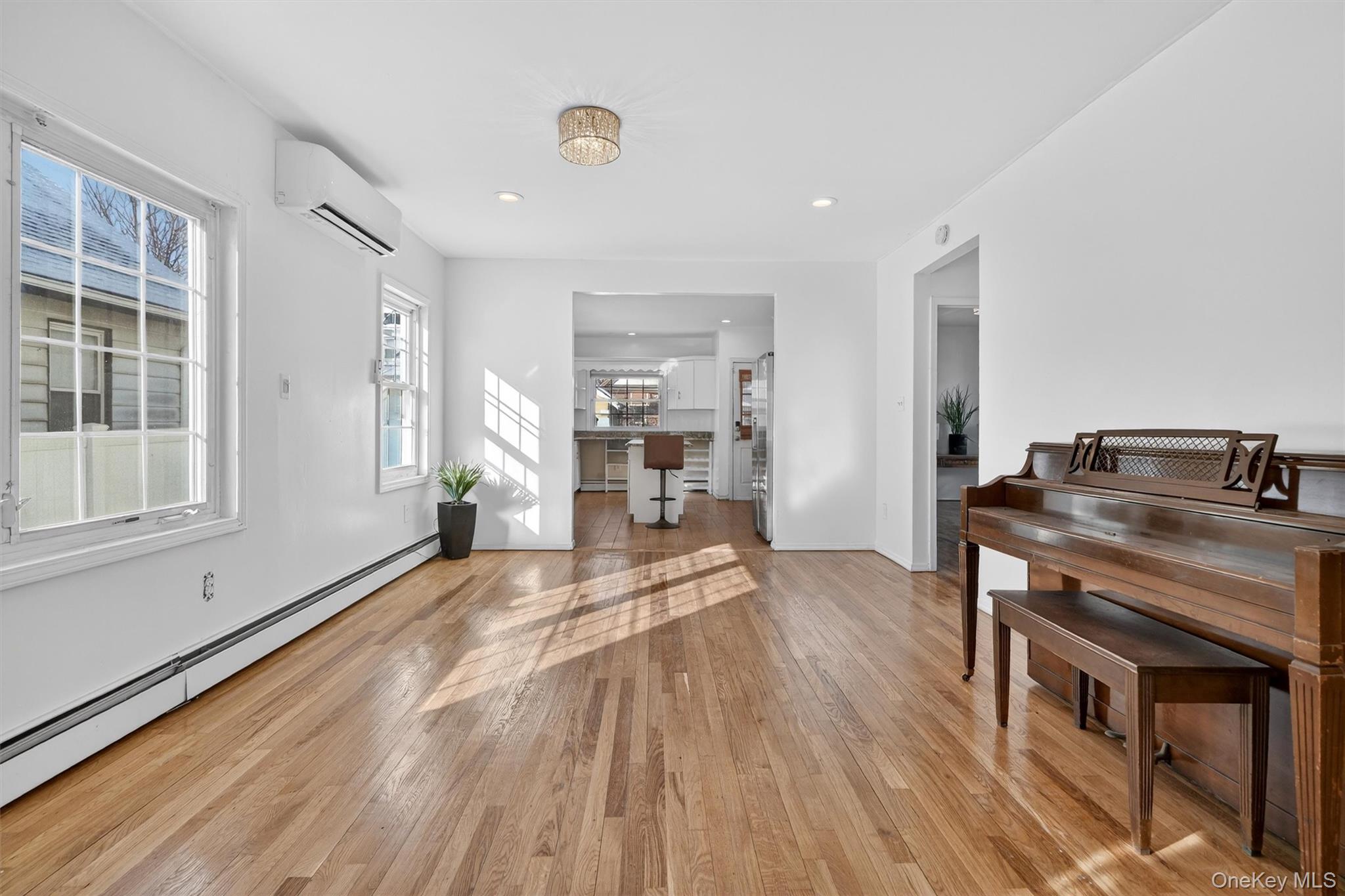 138-16 230th Street Queens, NY 11413 - Photo 7 of 49 Dining area with light wood-style floors, baseboard heating, a wall mounted AC, and recessed lighting