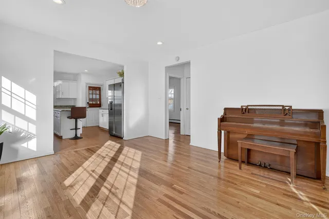 a living room with furniture and a piano