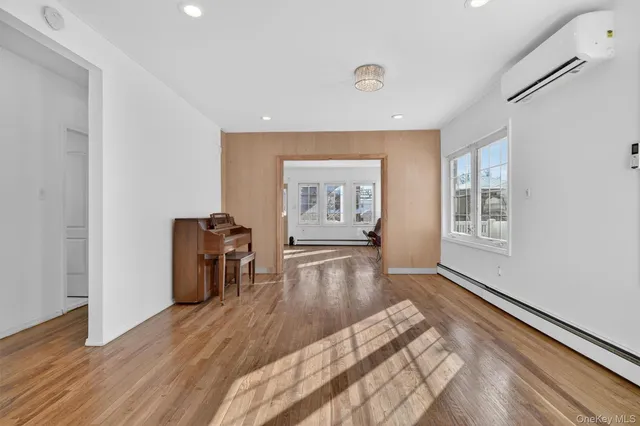a view of a big room with wooden floor windows and entryway