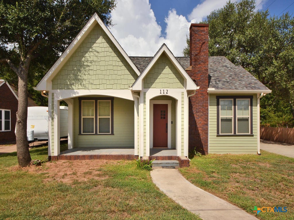 a front view of a house with garden
