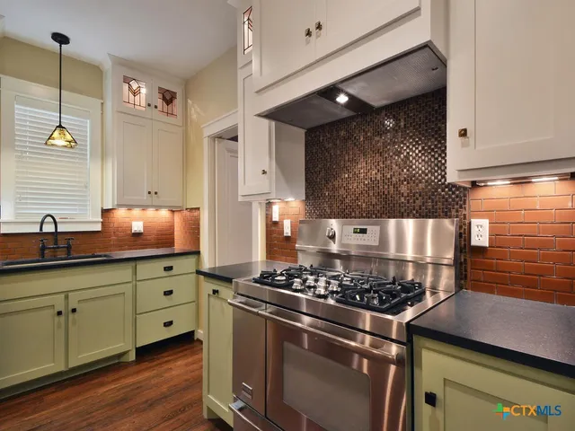 a kitchen with a table chairs and a stove