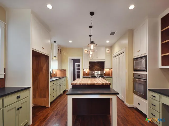 a view of bathroom with mirror and wooden floor