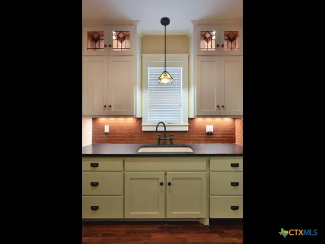 a close view of water heater and cabinet in a room