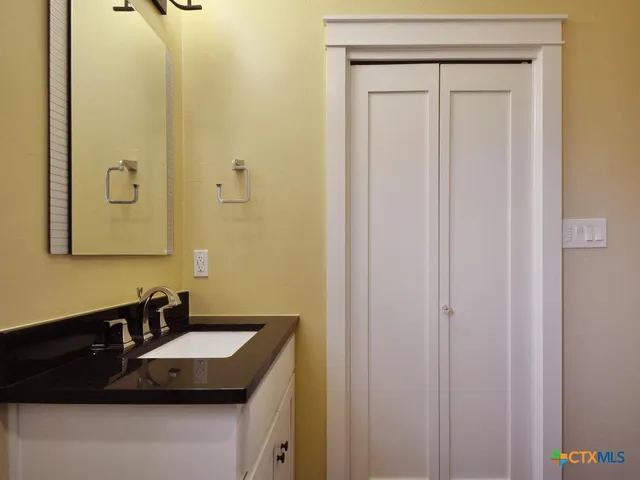 a bathroom with a sink and a mirror