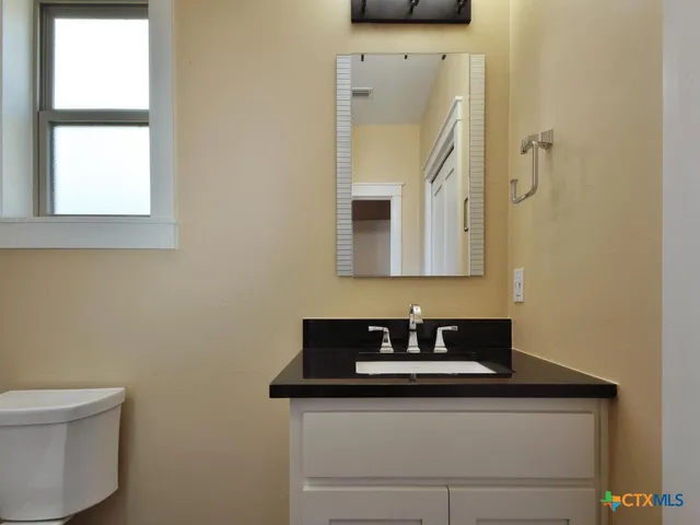 a view of a bathroom from a hallway