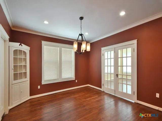 a view of a livingroom with wooden floor and a ceiling fan