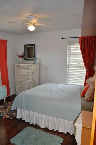 a bedroom with a bed and a television