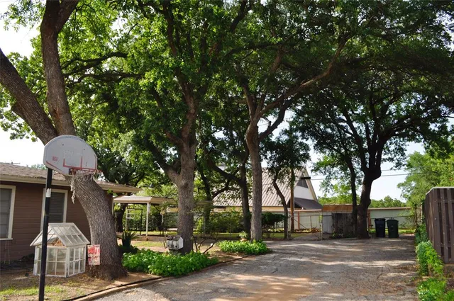 a front view of a house with a tree