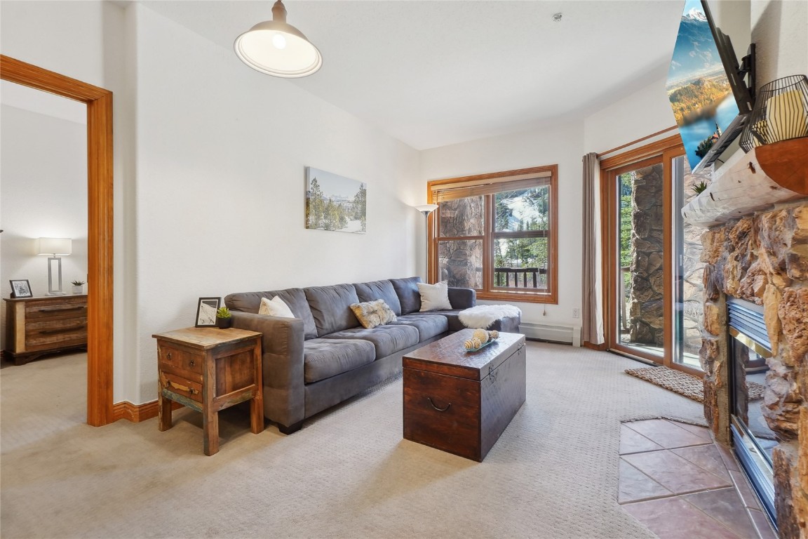 22714 Highway 6, Unit 5941 Keystone, CO 80435 - Photo 13 of 41 a living room with furniture a fireplace and a flat screen tv
