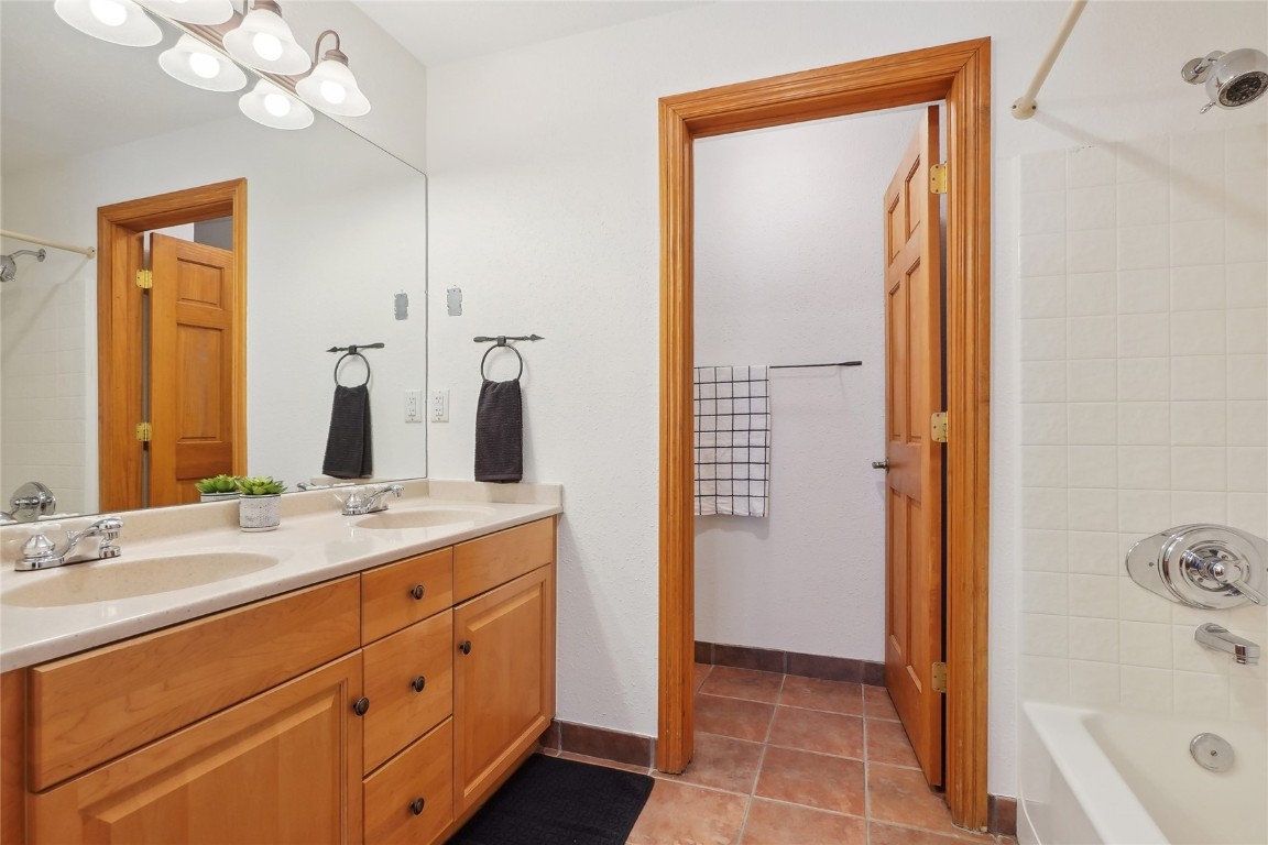 22714 Highway 6, Unit 5941 Keystone, CO 80435 - Photo 17 of 41 a bathroom with a granite countertop sink mirror and a bathtub