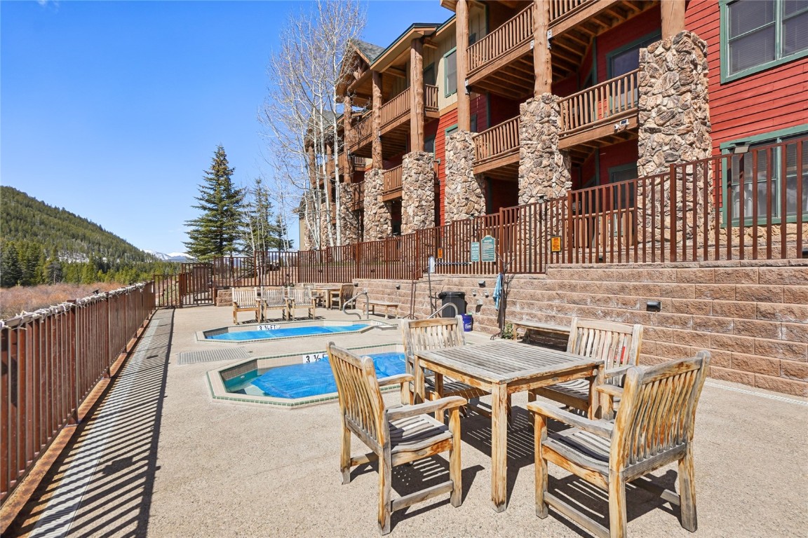 22714 Highway 6, Unit 5941 Keystone, CO 80435 - Photo 26 of 41 a swimming pool with outdoor seating and yard