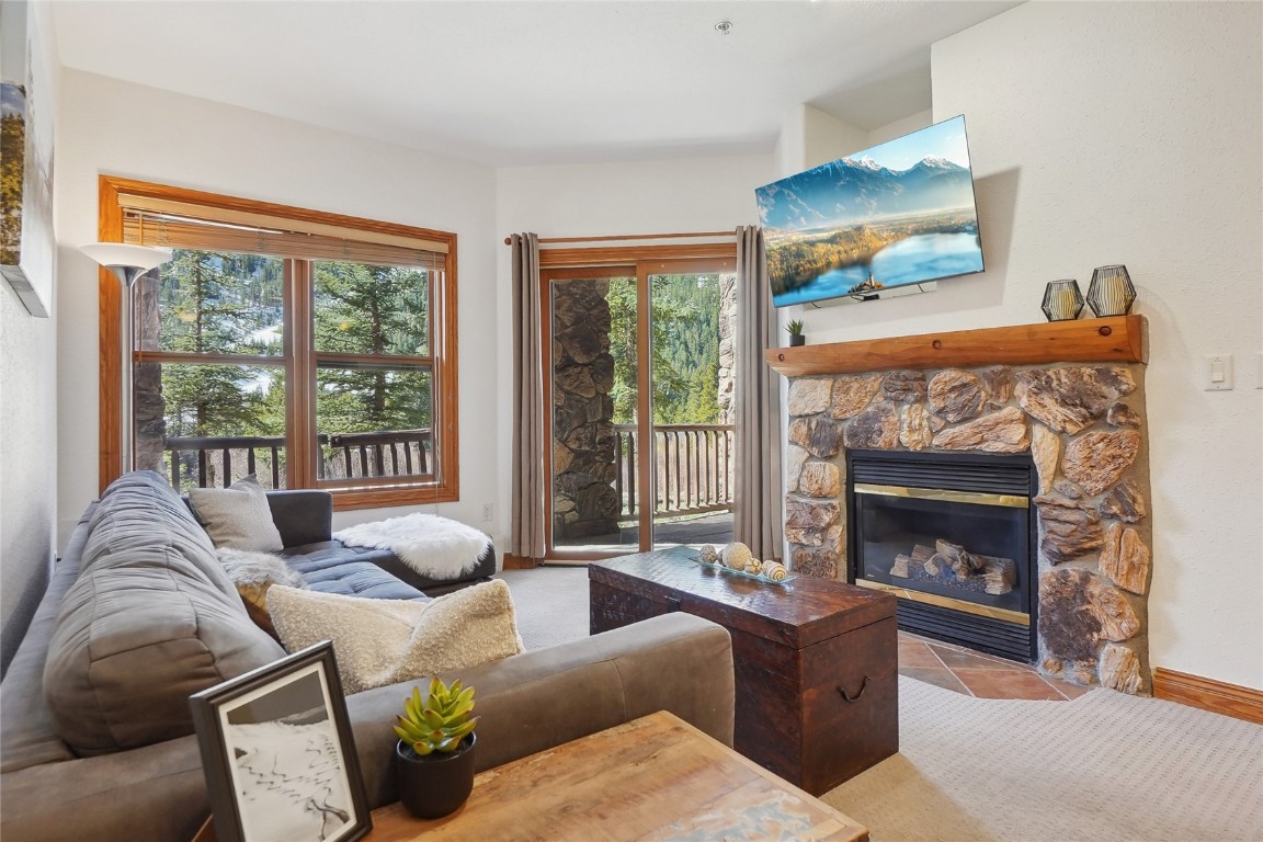 22714 Highway 6, Unit 5941 Keystone, CO 80435 - Photo 3 of 41 a living room with furniture and a fireplace