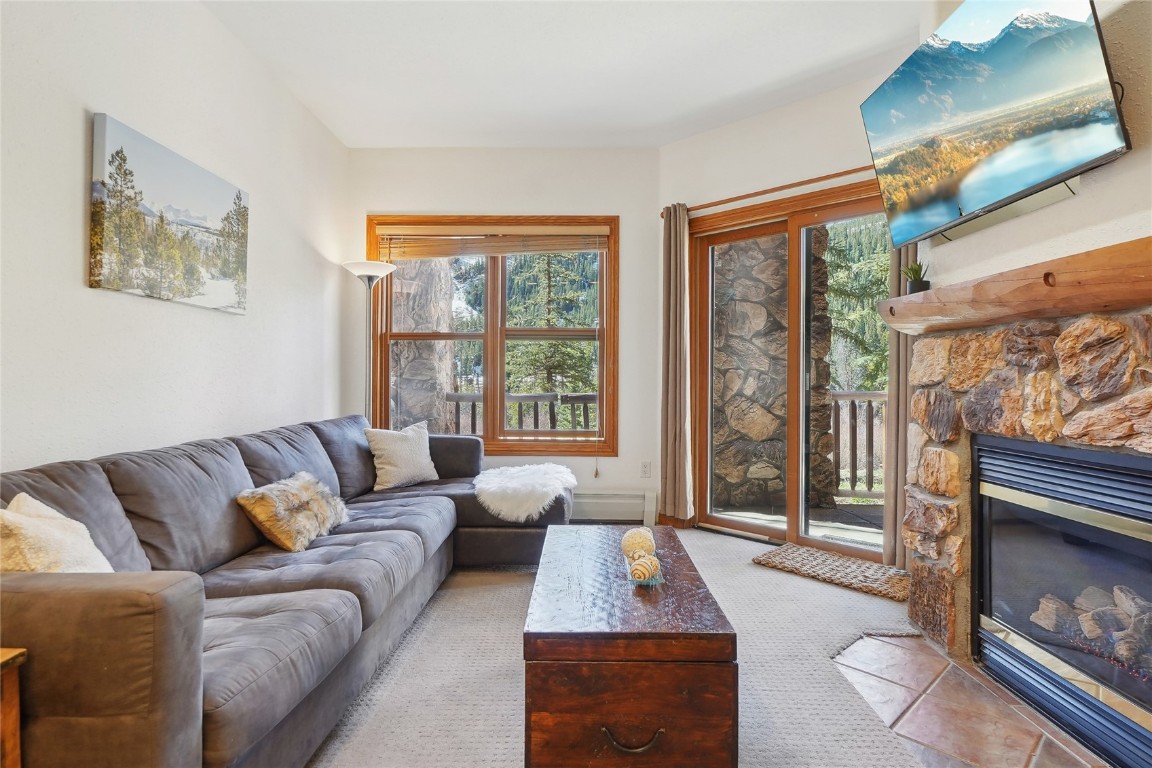 22714 Highway 6, Unit 5941 Keystone, CO 80435 - Photo 4 of 41 a living room with furniture and a fireplace